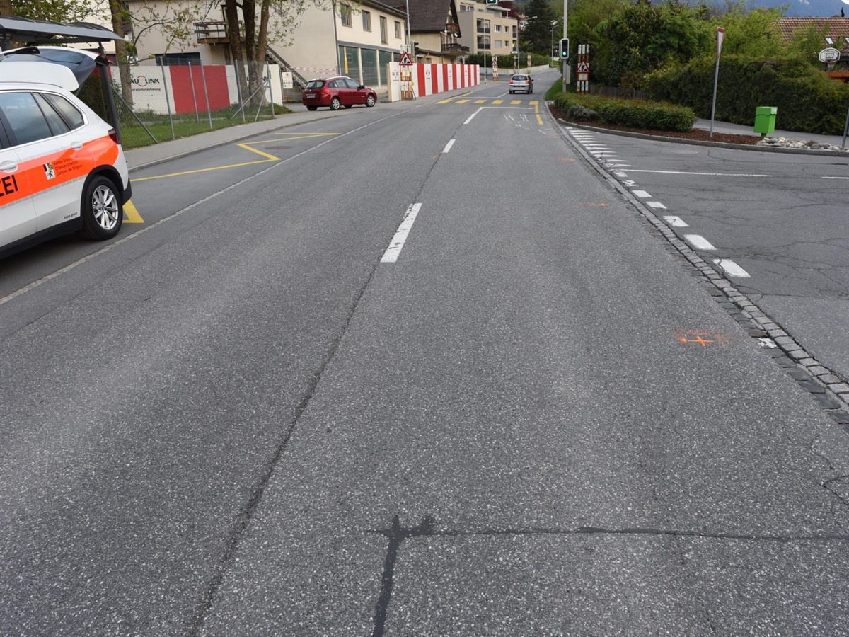 Übersichtsaufnahme der Deutschen Strasse in Fahrtrichtung Zizers mit dem linksseitig abgehenden Castaletweg. Am linken Bildrand ist das Heck eines Patrouillenwagens sichtbar.