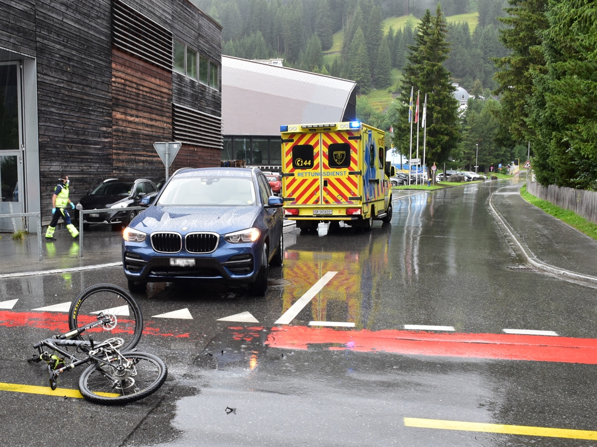 Verzweigung Talstrasse – Kurgartenstrasse mit Blick in Richtung Promenade. Auf der Verzweigung steht das Auto und vor diesem liegt das Fahrrad. Hinter dem Auto steht ein Ambulanzfahrzeug. Ein Rettungssanitäter läuft auf dieses zu.
