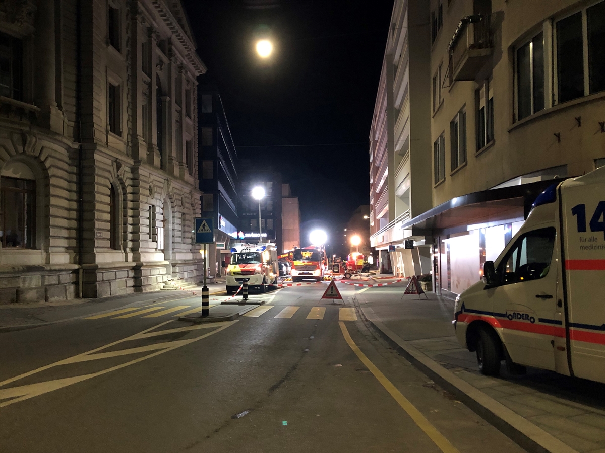 Blick auf die Gäuggelistrasse. Links und rechts eine Häuserfront. Rechts das fragliche Gebäude. Auf der Strasse Feuerwehrfahrzeuge und rechts auf einem Vorplatz ein Ambulanzfahrzeug. 